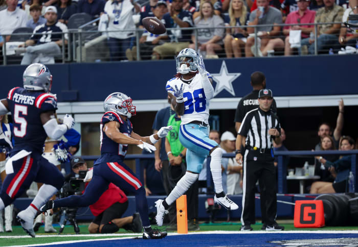 Oct 1, 2023; Arlington, Texas, USA; Dallas Cowboys wide receiver CeeDee Lamb (88) catches a touchdown pass over New England Patriots cornerback Myles Bryant (27) during the first quarter at AT&T Stadium. Mandatory Credit: Kevin Jairaj-USA TODAY Sports